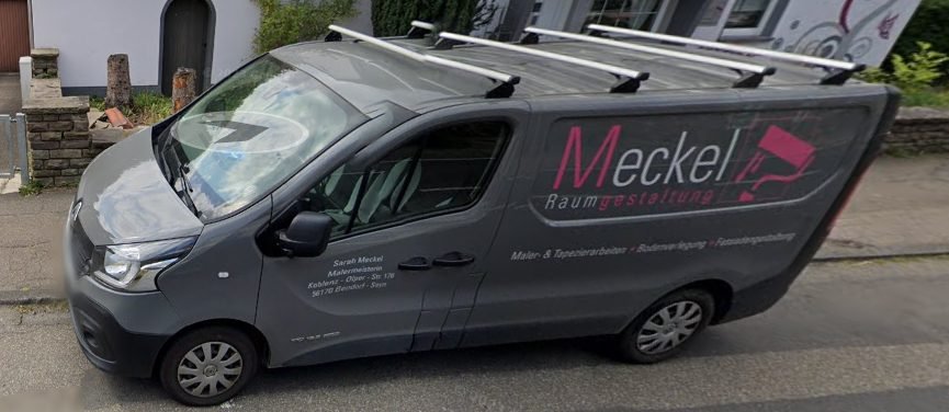 The Meckel Raumgestaltung van parked at a job, grey with the wine-red script logo